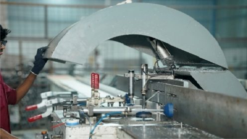 worker cutting aluminium profiles with precision machine for formwork manufacturing